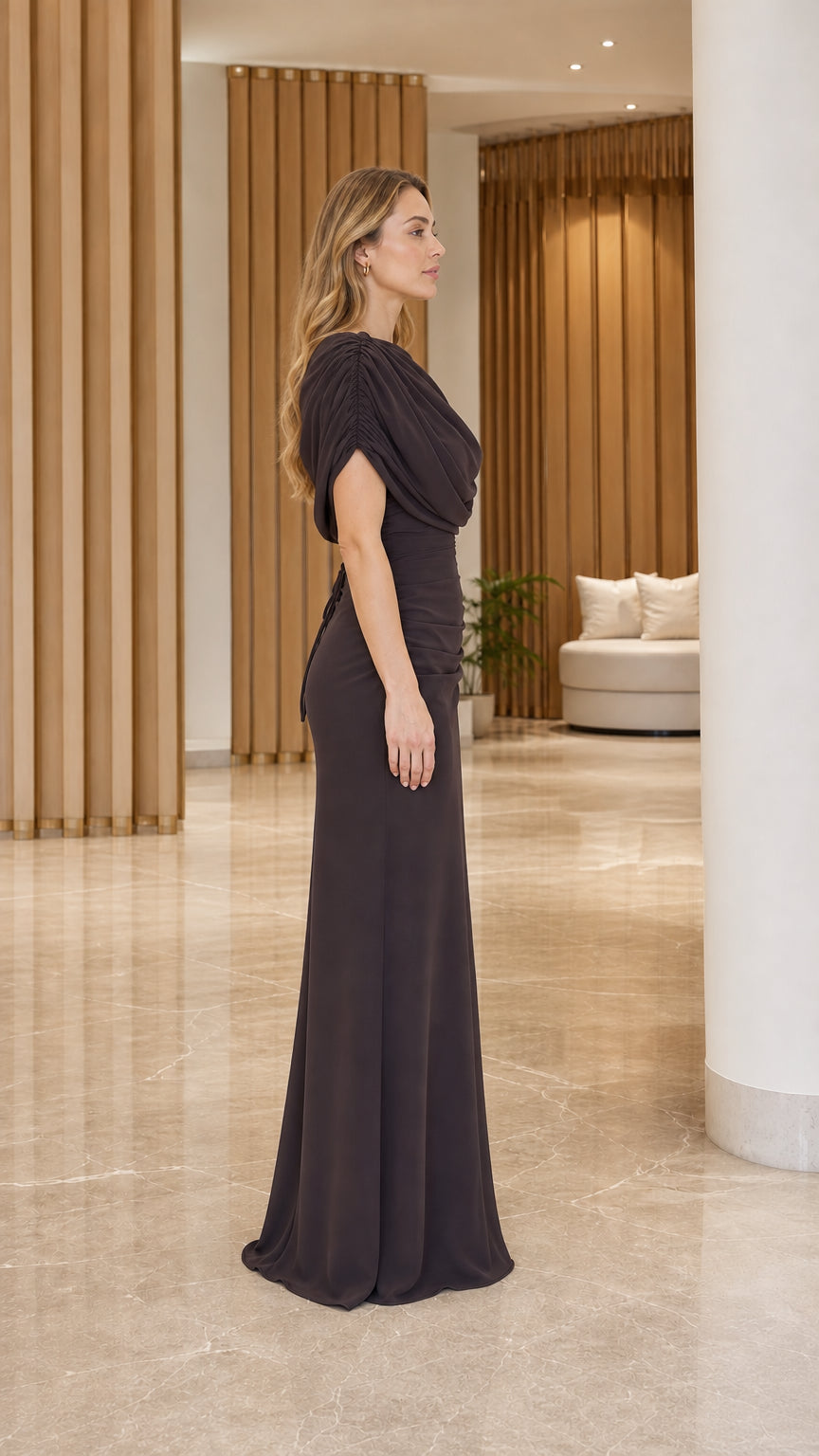 Side profile of model in espresso brown draped formal maxi dress