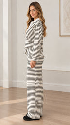 Side profile view of woman wearing white striped polo lounge set