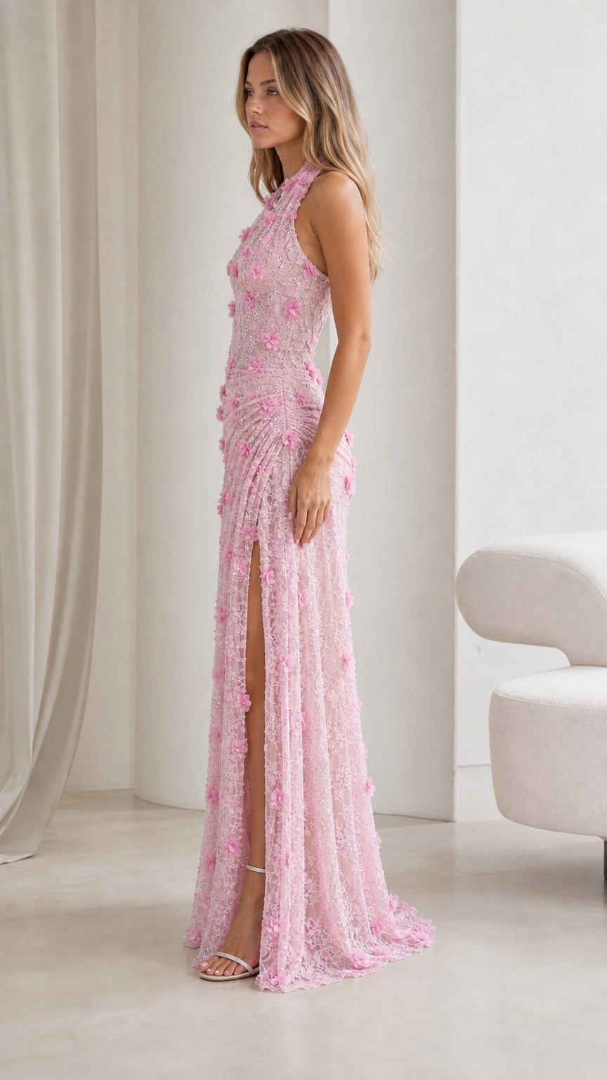 Side profile view of blush pink floral lace gown showing gathered waist and slit