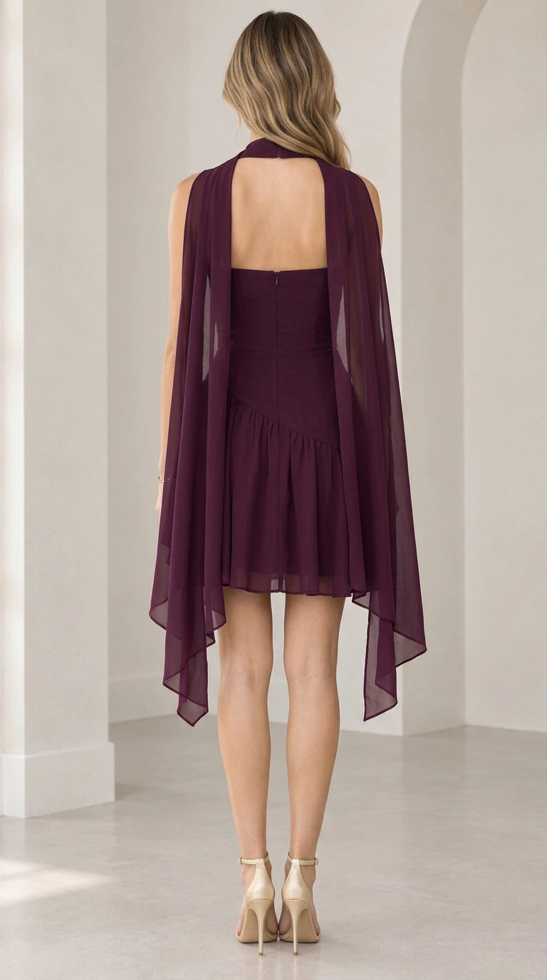 Back view of model wearing Burgundy Choker Capelet Asymmetric Ruffle Mini Dress showing open back cape drape