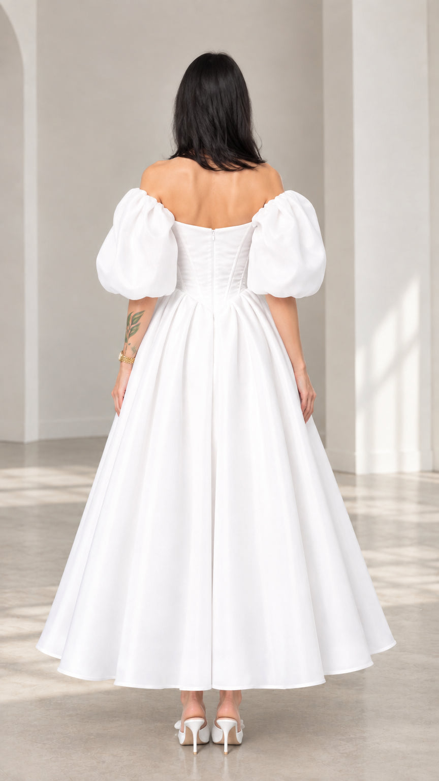 Rear view of a white off-shoulder puff sleeve evening gown showing back zipper closure