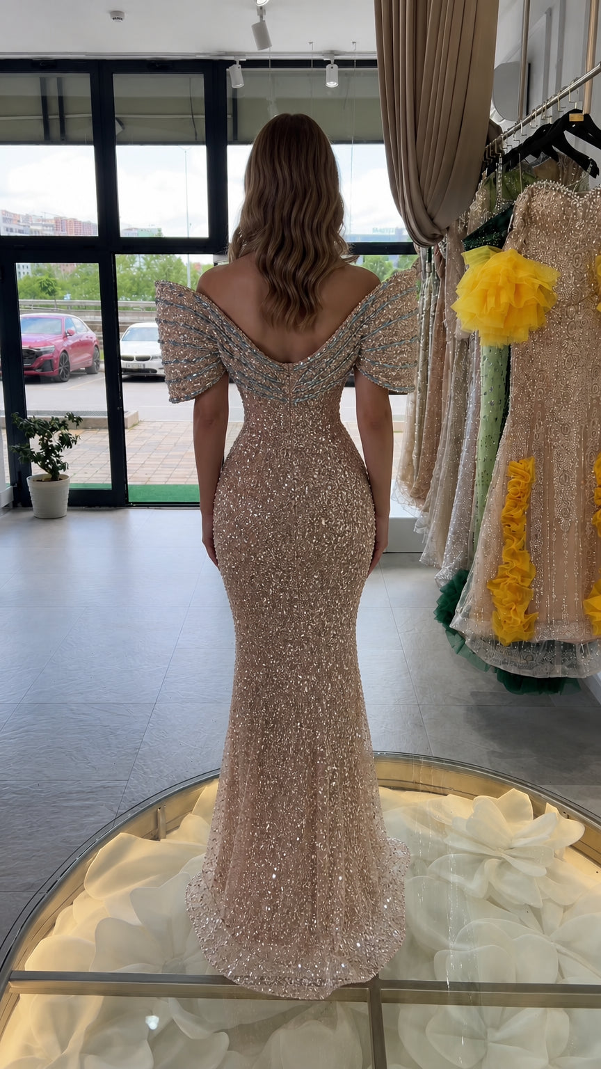 Rear view of champagne sequin maxi formal gown featuring low V-back design