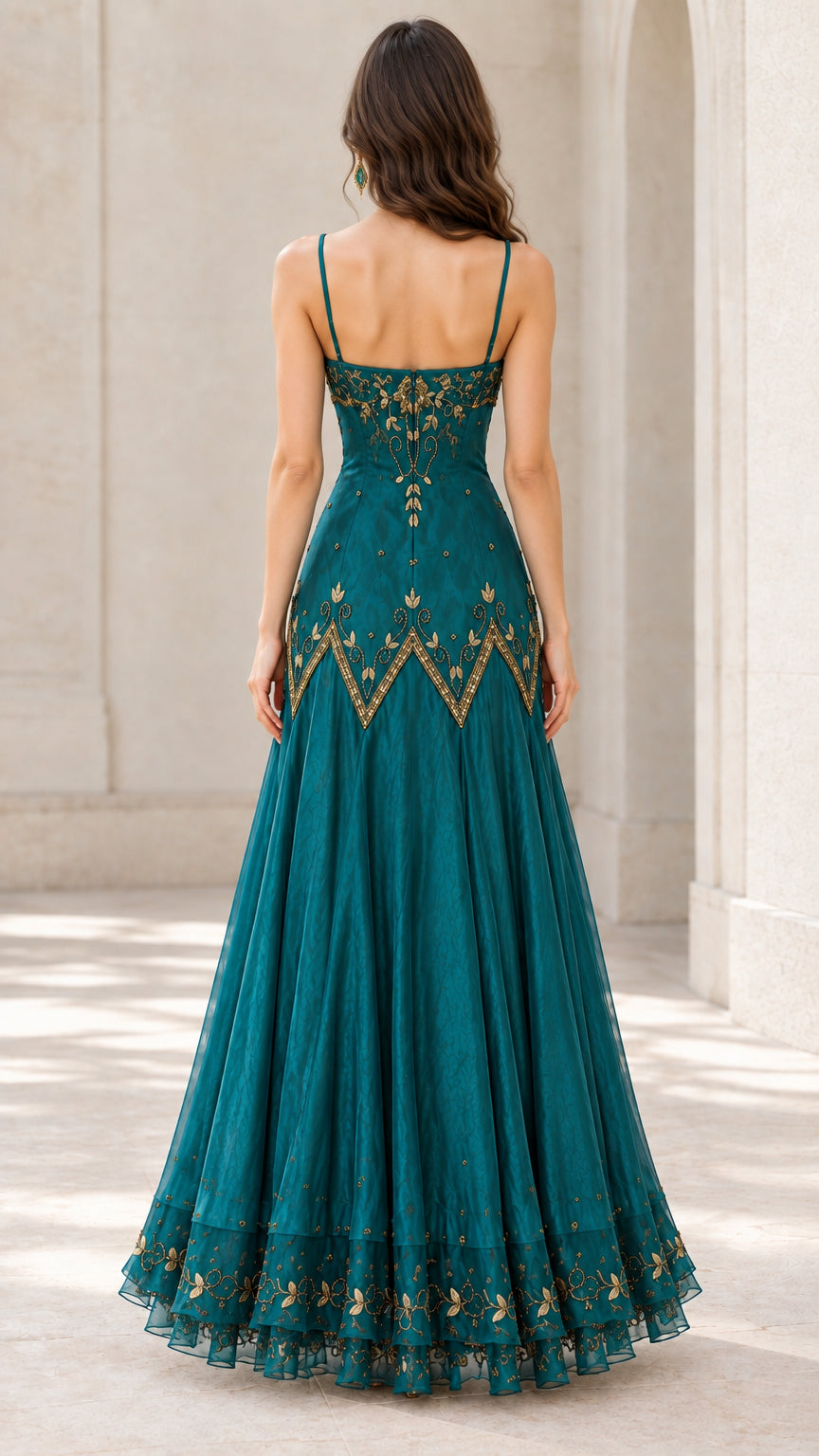 Back view of woman wearing teal embroidered evening dress with spaghetti straps