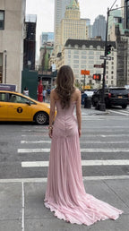 Back view of woman showcasing the low back and cascading train of the blush pink gown