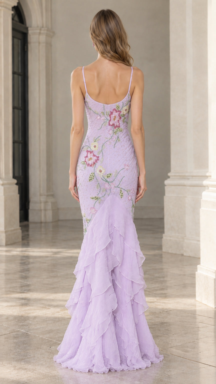 Back view of model in lavender spaghetti strap gown displaying low scoop back and floor-length tiered ruffle hem
