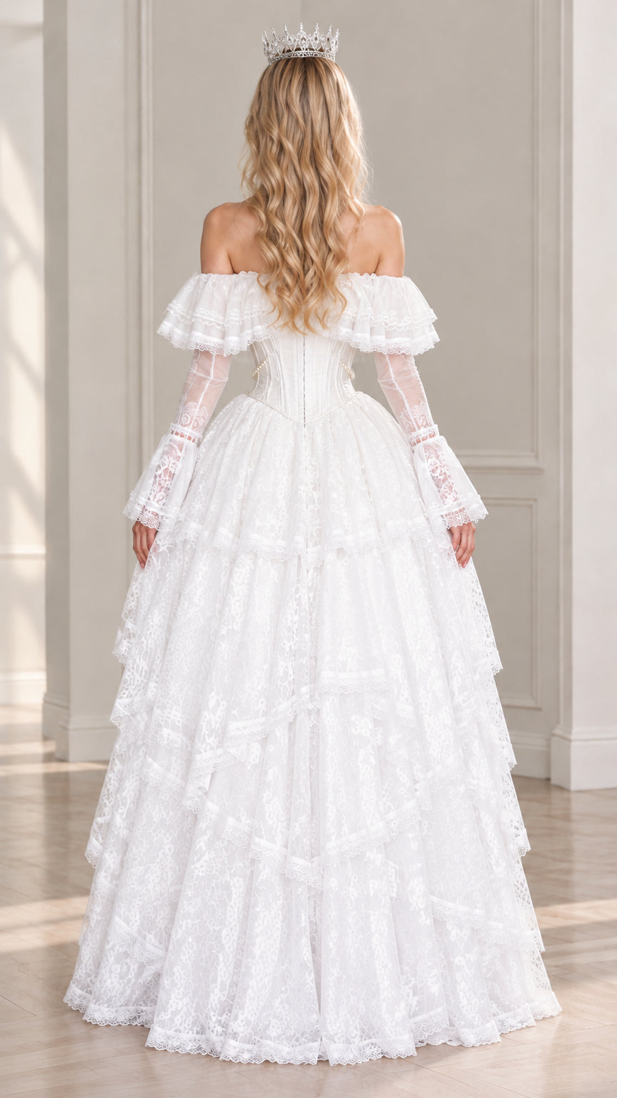 Back view of model in white off-shoulder lace gown featuring floor-length tiered skirt