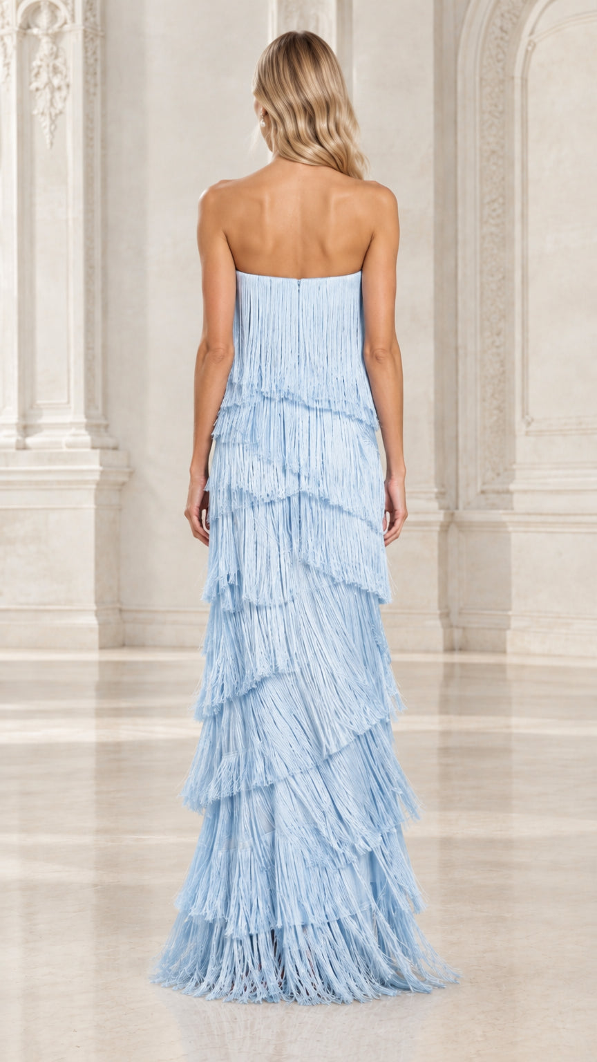 Back view of model showcasing light blue strapless tiered fringe maxi gown