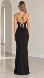 Back view of model showing the crisscross lace-up open back design on the black gown