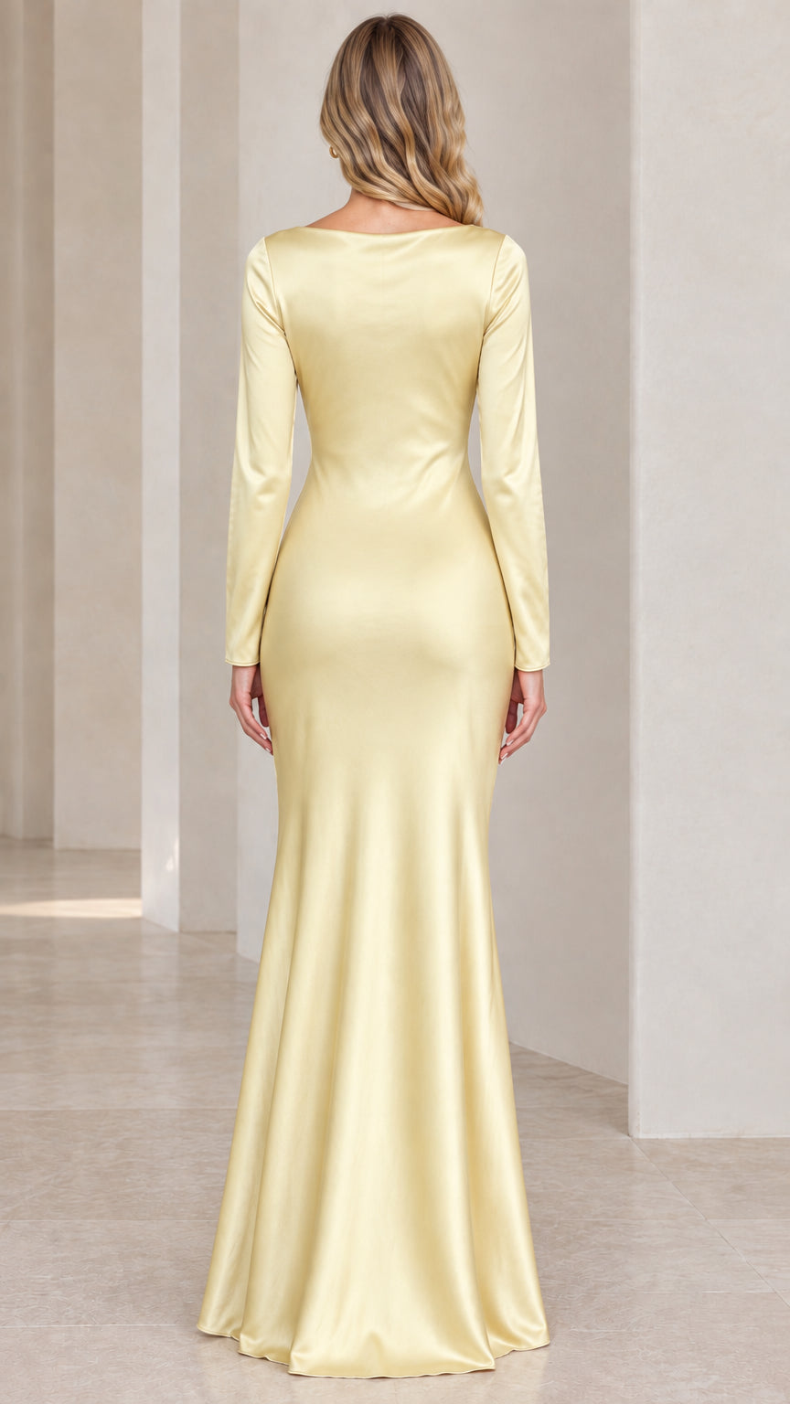 Back full-length view of model wearing pastel yellow long sleeve satin floor-length dress