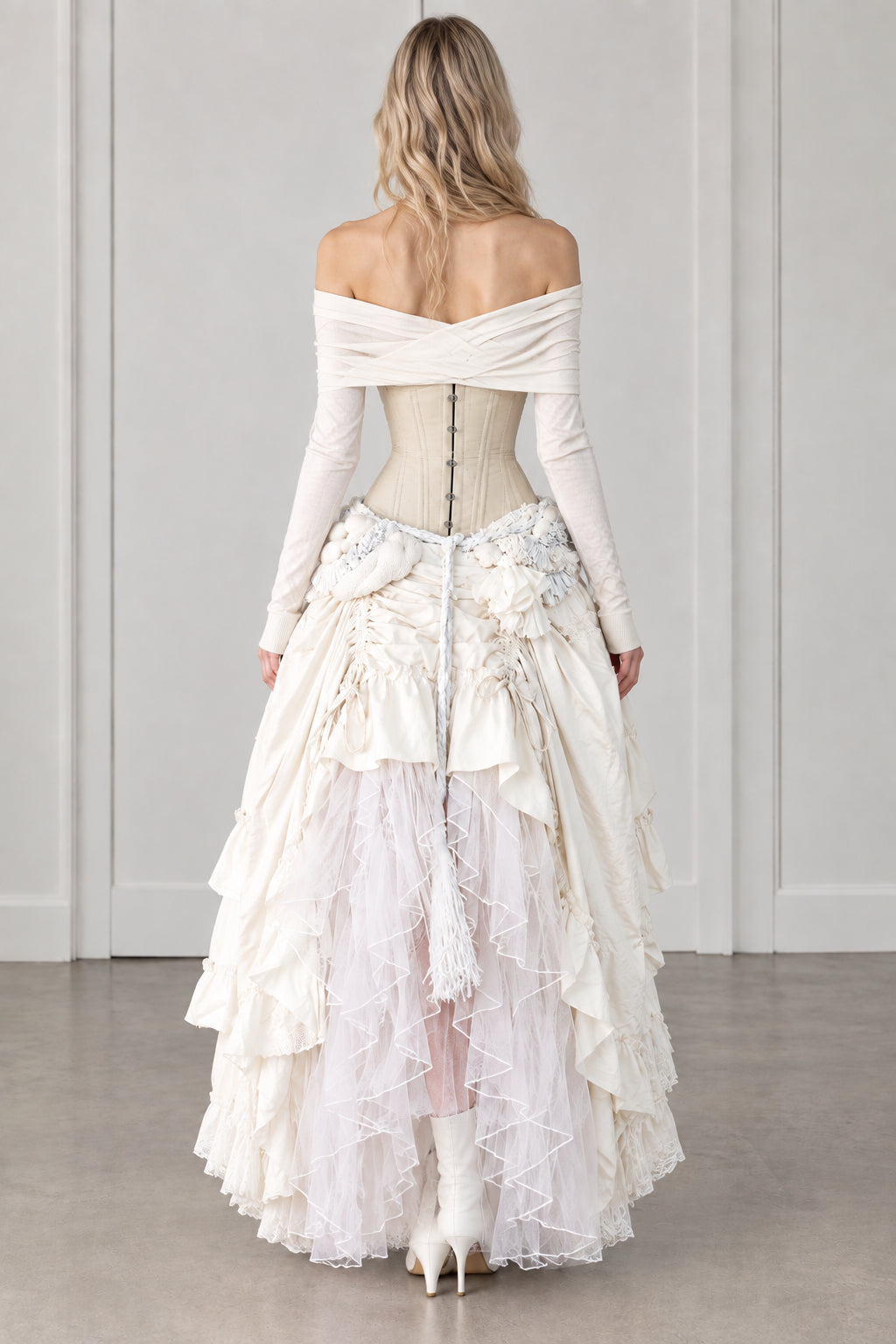 Back view of model wearing ivory off-shoulder corset tiered maxi dress