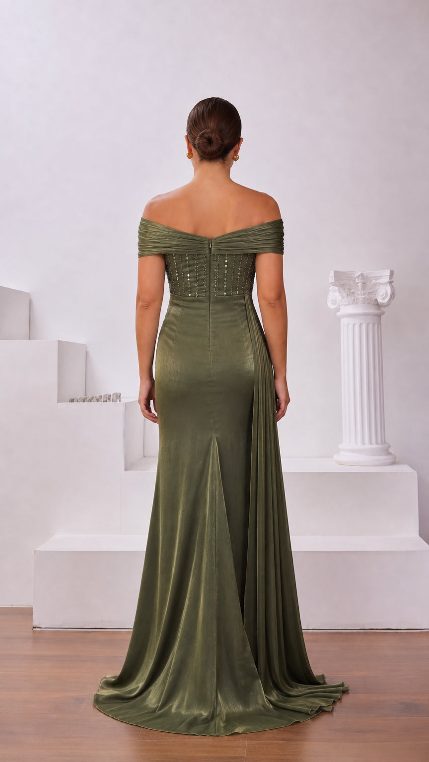 Back view of olive green off-shoulder evening gown showing structured fit and subtle train