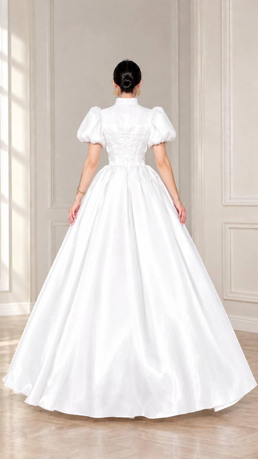 Back view of white satin ball gown showing lace-up corset detail