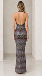 Model wearing multicolor metallic chevron halter maxi dress showing open back