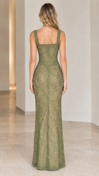 Back view of model showcasing square back and mermaid hem on sage green lace maxi dress