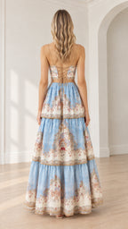 Back view of model showing lace-up corset detail on light blue floral tiered maxi dress