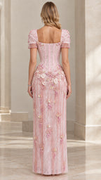 Back view of woman wearing pink corseted evening dress with square backline