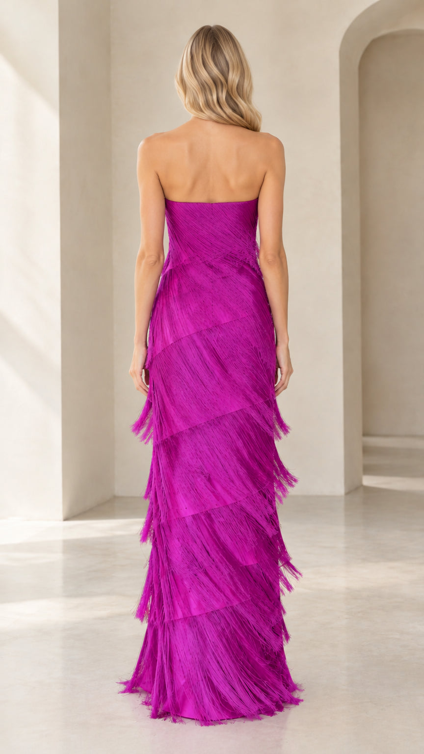 Back view of model wearing magenta strapless tiered fringe column dress