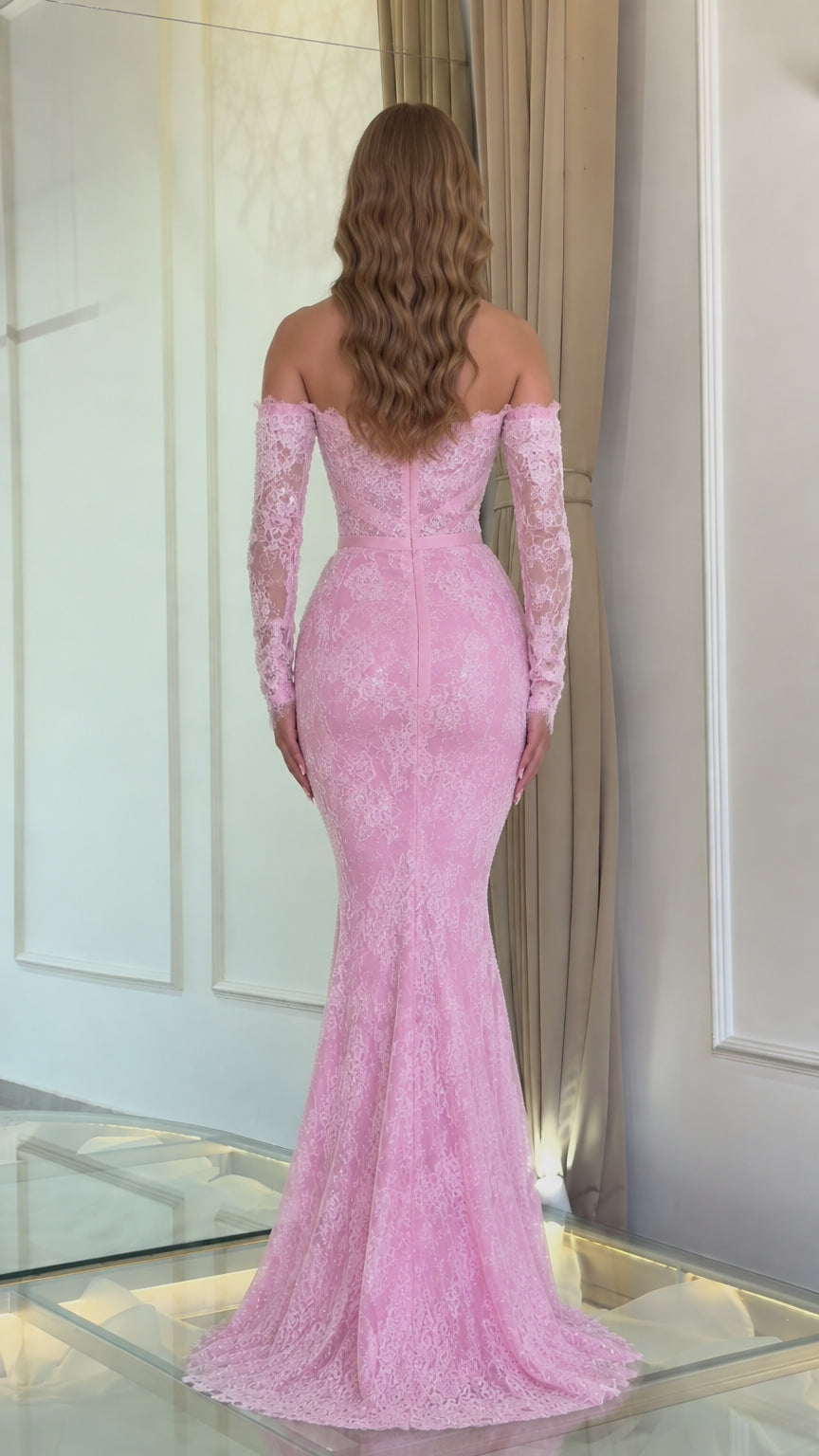 Back view of pink lace long sleeve mermaid gown showing low back neckline and train