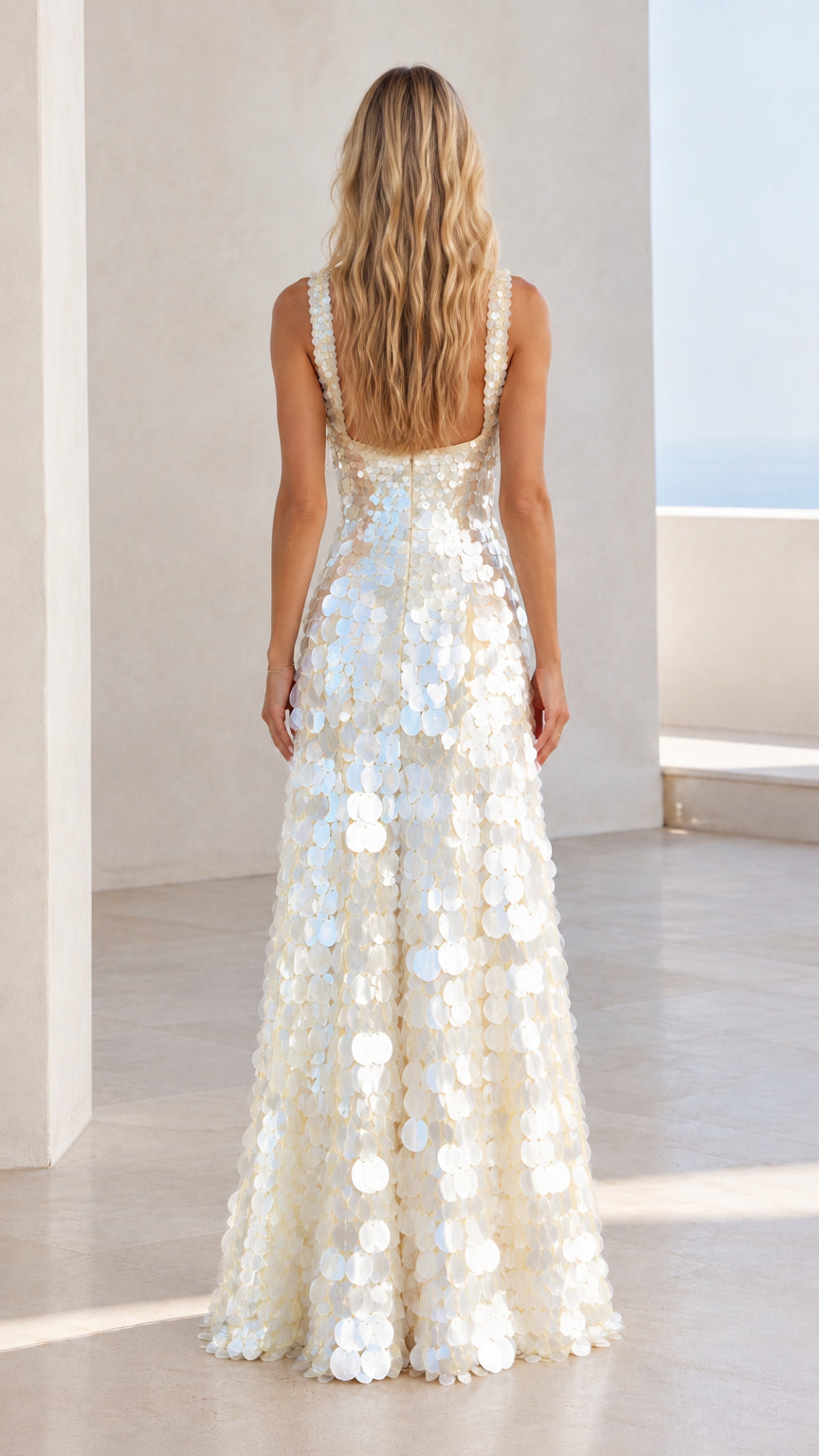 Back view of model wearing white sequin square-neck evening gown