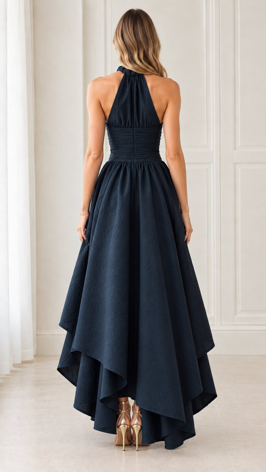 Back view of model showing halter neckline and tiered cascading skirt in Navy Blue