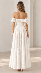 Back view of a woman wearing a white off-the-shoulder floral lace maxi dress showing the back neckline