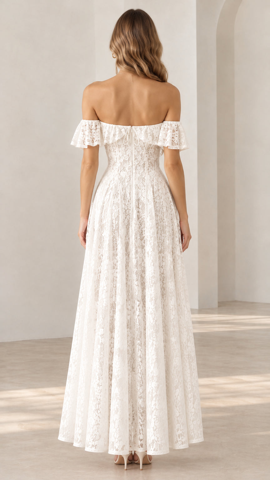 Back view of a woman wearing a white off-the-shoulder floral lace maxi dress showing the back neckline