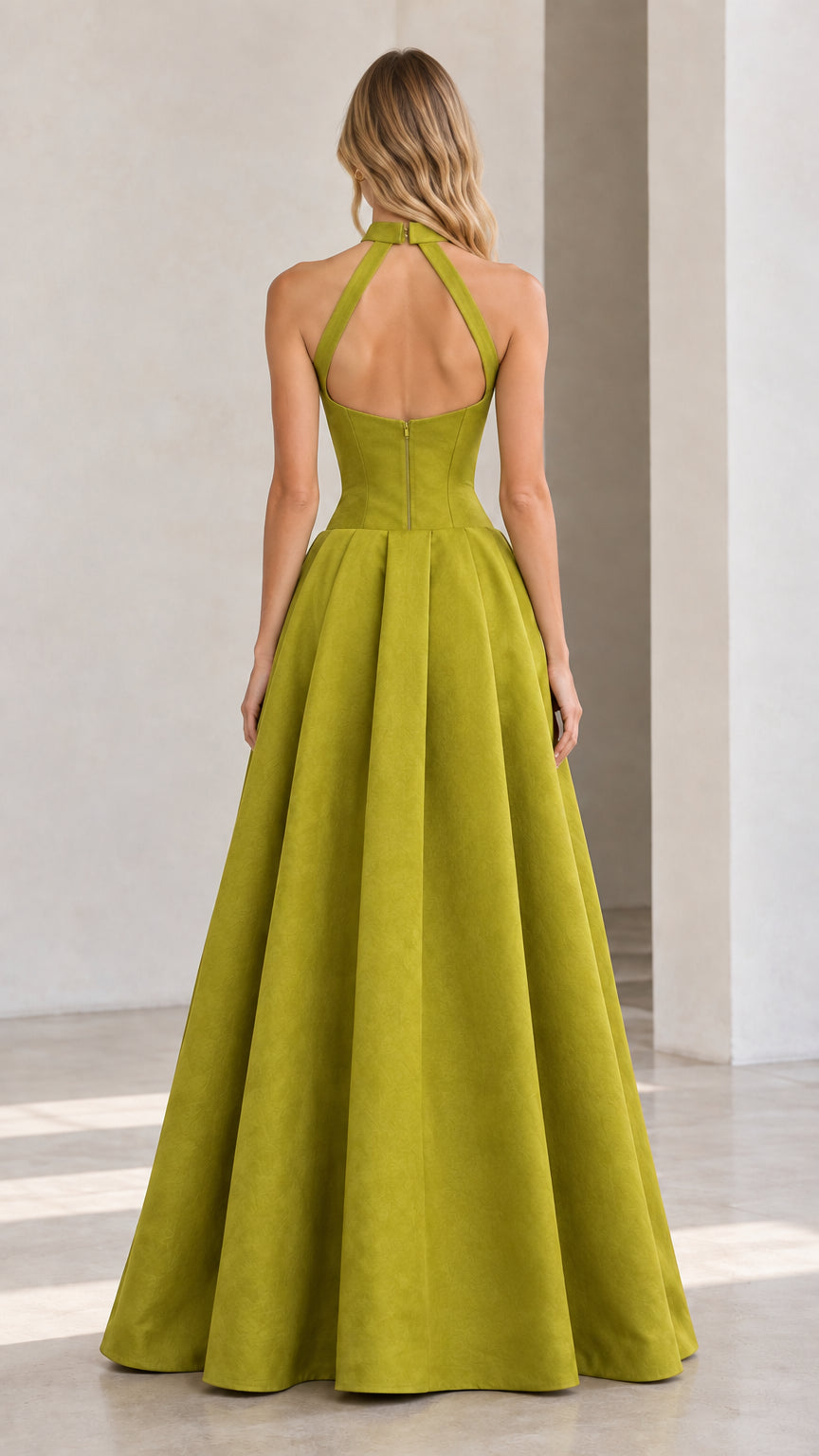 Back full-length view displaying open cutout back and floor-length pleated skirt