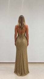 Rear view showcasing open lace-up back of gold formal evening gown