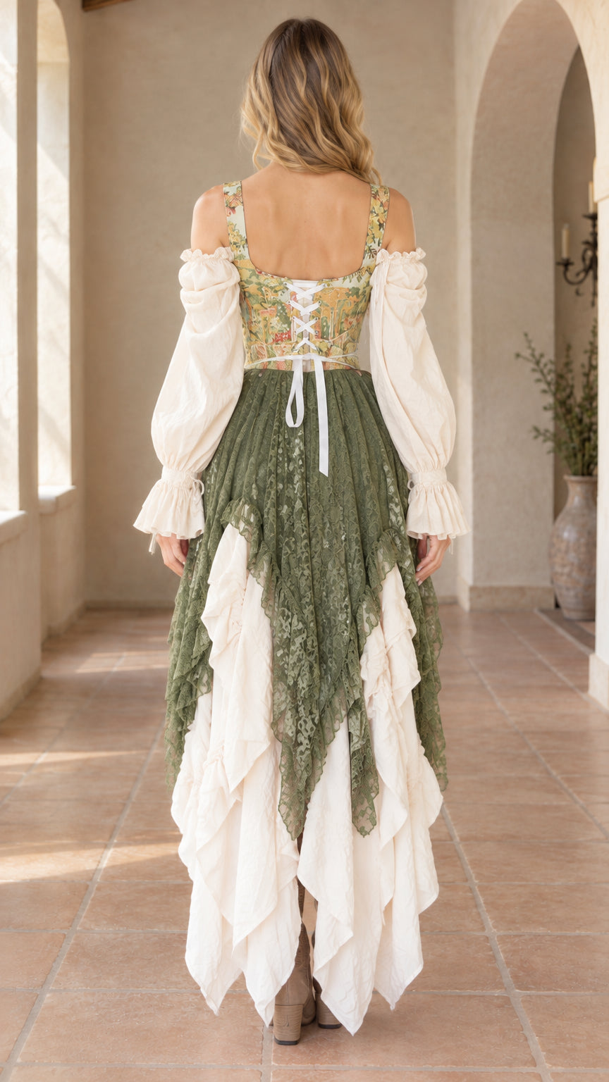 Back view of model showing the lace-up ribbon back and tiered lace skirt of the olive green dress