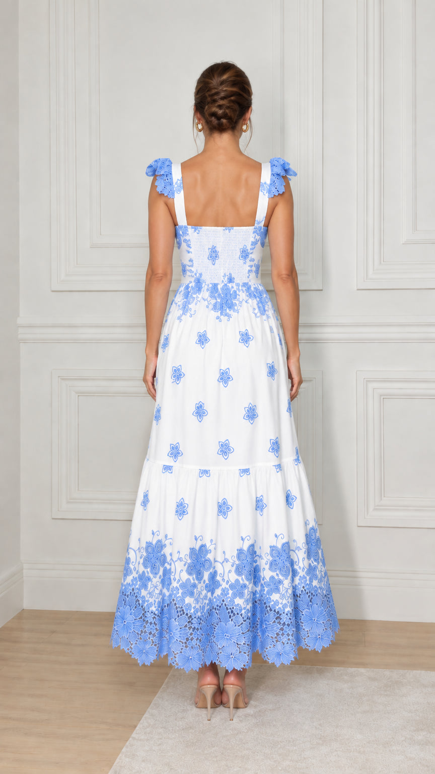 Back view of white maxi dress showing smocked back bodice and lace shoulder straps