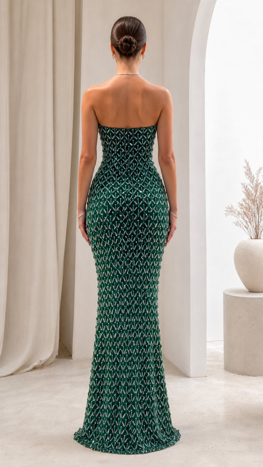 Back view of model wearing Emerald Green strapless beaded maxi gown