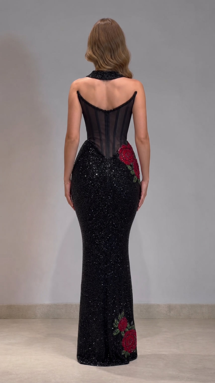 Back view of black mermaid evening gown with sheer corset back and collar strap