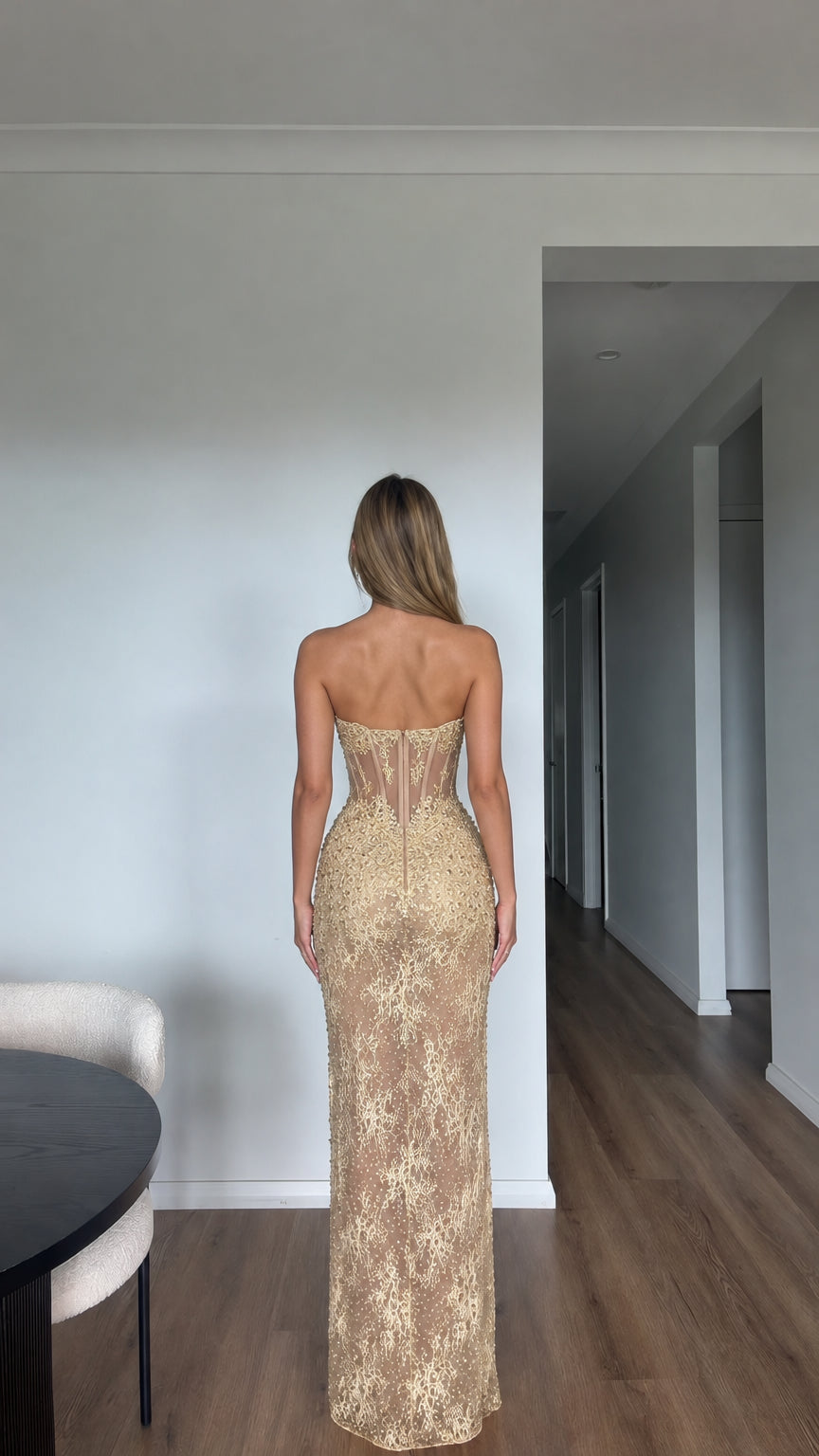 Back view of model in Champagne Gold strapless lace evening gown showing boned corset back