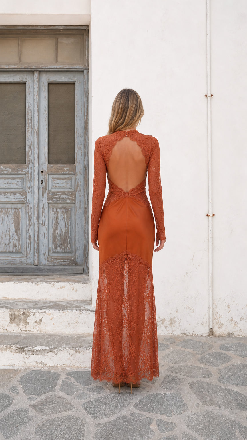 Back view of model showing open cutout back detail on Terracotta maxi dress