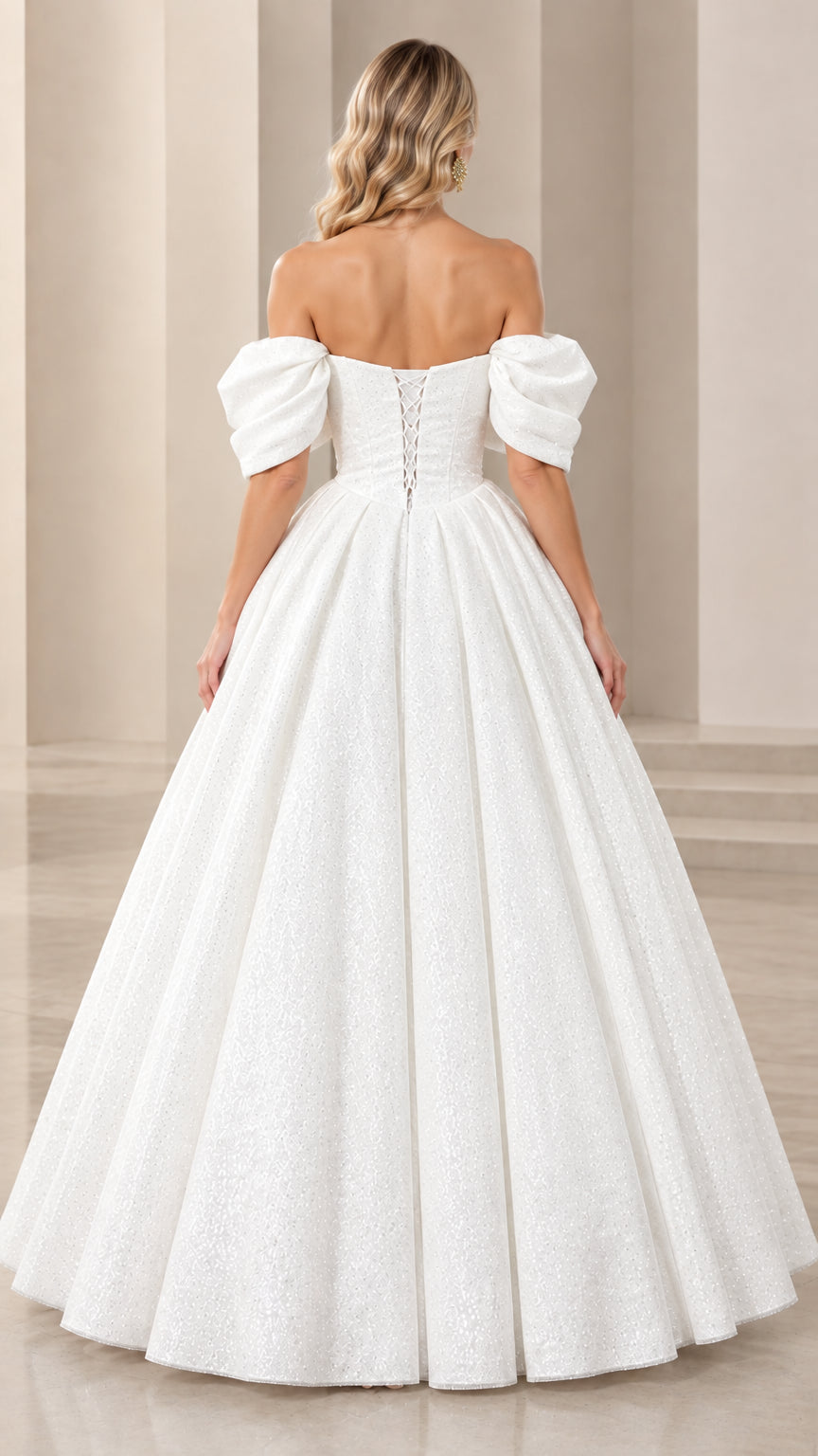 Back view of white formal gown showing lace-up corset closure and sweeping hemline