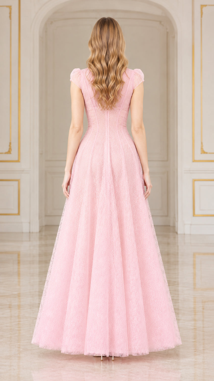 Back view of woman wearing pink lace maxi gown with cap sleeves