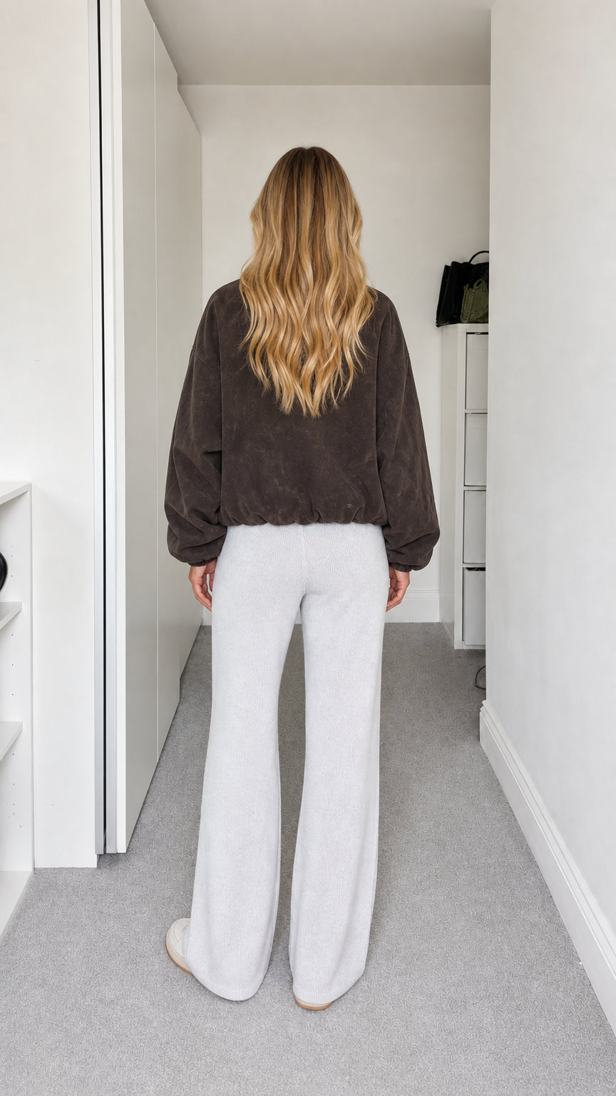 Back view of model wearing dark brown fleece jacket