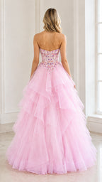 Back view of woman wearing a strapless pink formal ball gown with tiered tulle skirt