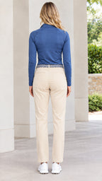 Back view of woman wearing blue long sleeve quarter-zip pullover top