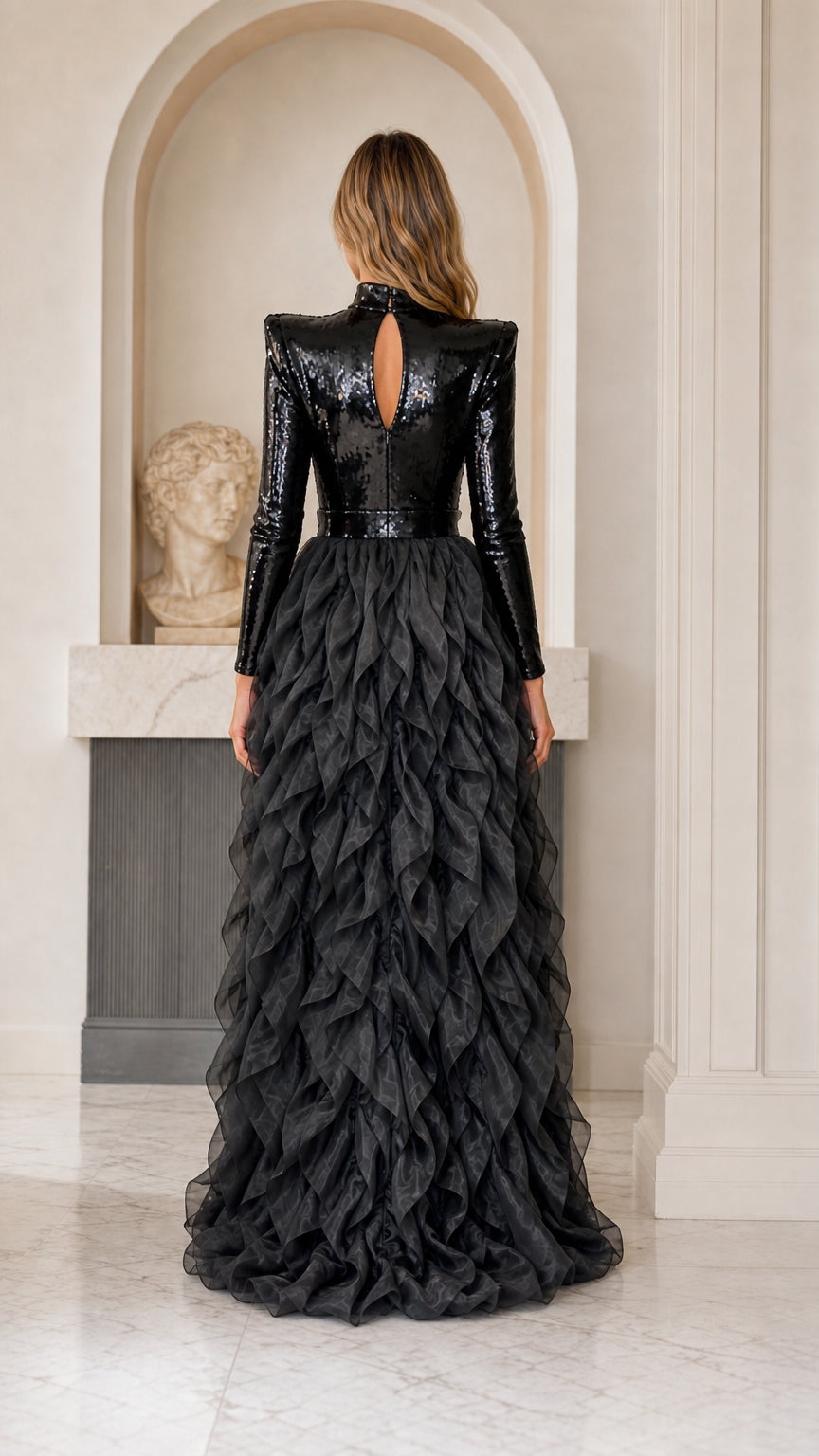 Back view of black sequin evening gown featuring keyhole opening and sweeping ruffle train
