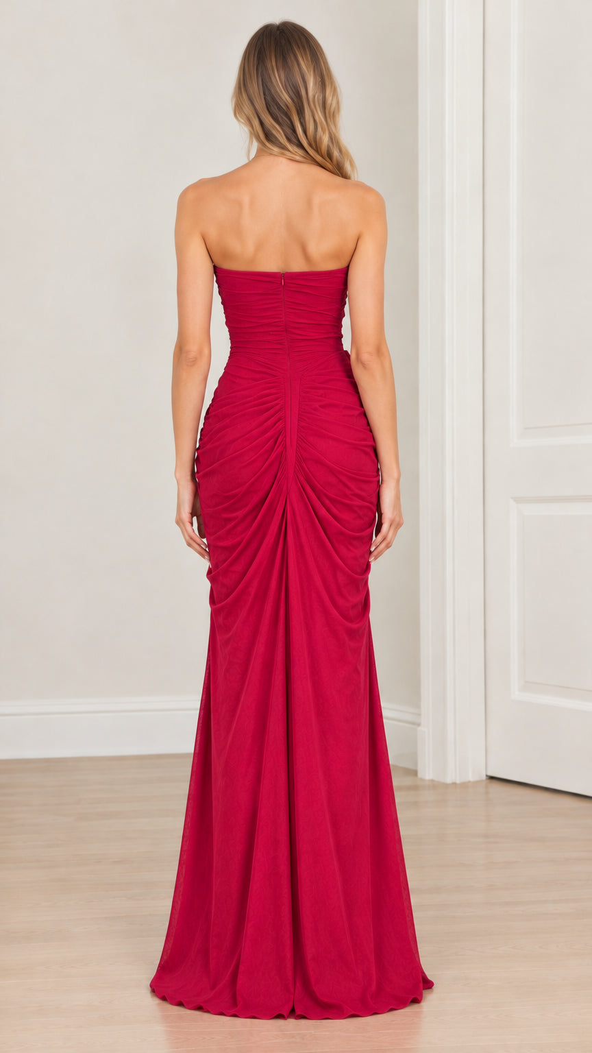 Back full-length view of model wearing magenta strapless ruched maxi dress