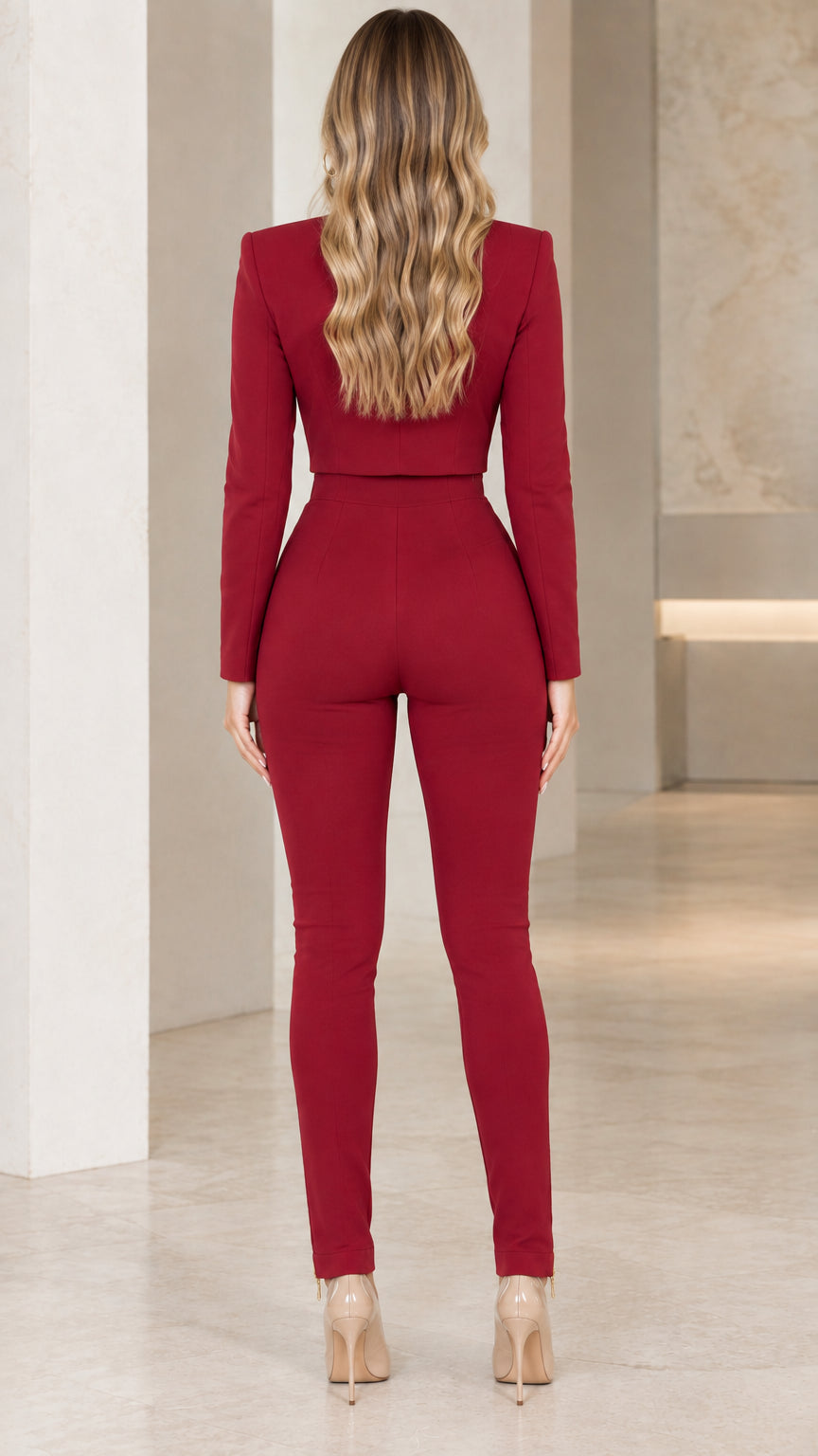 Rear view of model wearing tailored burgundy two-piece jacket and pants set