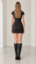 Back view of model in fitted charcoal plaid cheongsam mini dress