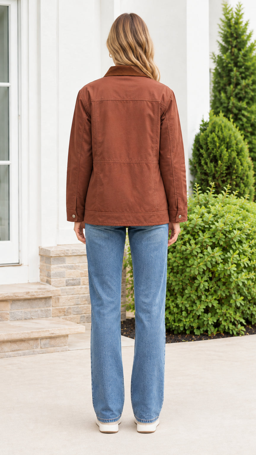 Back view of model wearing the brown canvas utility jacket showing straight relaxed hemline