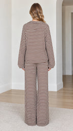 Back view of model wearing relaxed brown striped long sleeve top and wide leg pants