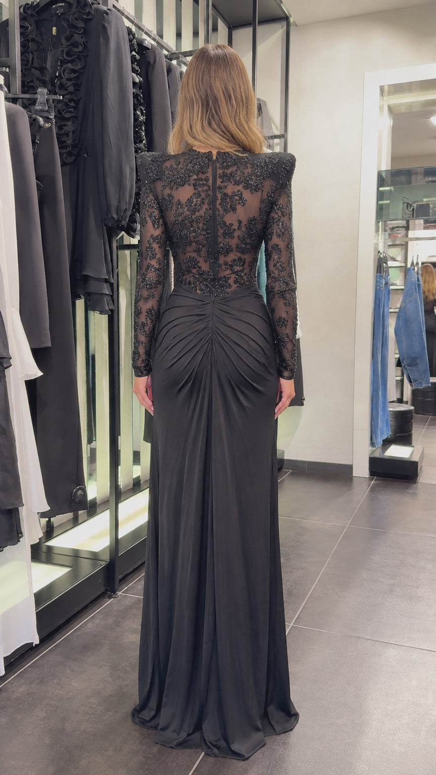 Back view of black long sleeve ruched maxi dress