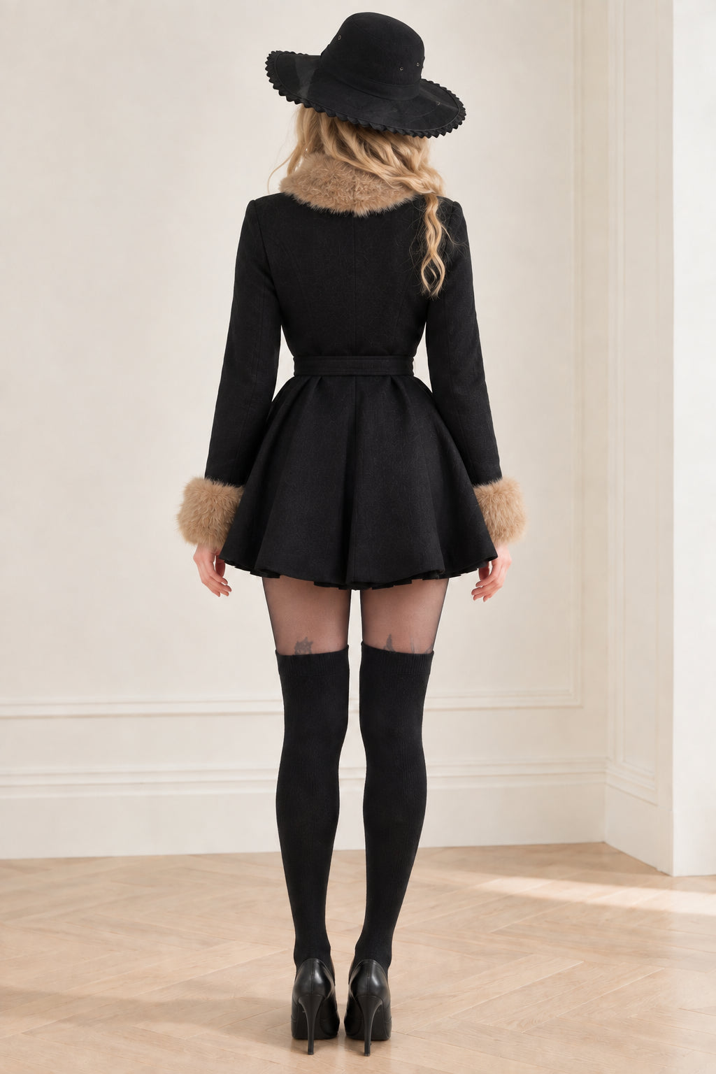 Back view of black fit and flare belted winter coat