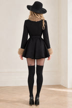 Back view of black fit and flare belted winter coat