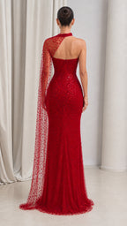 Back view of model in red floor-length sequin evening gown with sheer one-shoulder back