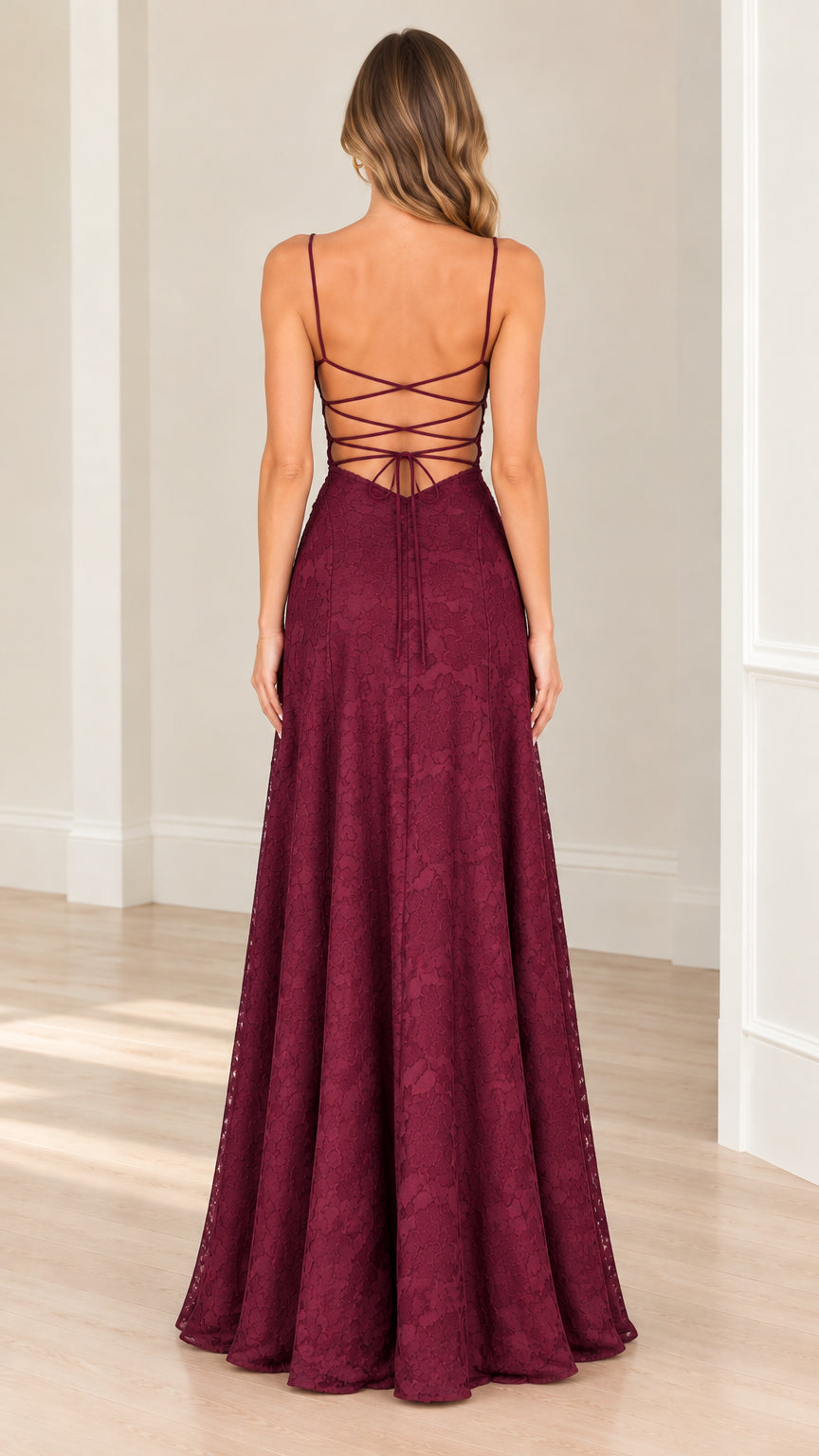 Back view of model in burgundy maxi gown highlighting the open back with crisscross strappy lace-up ties